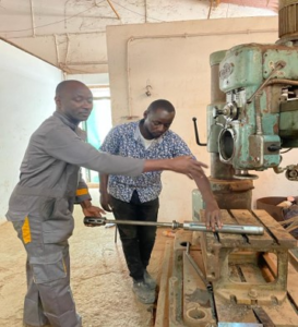 Mr. Nounagnon Hector Alexandre Vignon from Benin (left) with Mr. Demba Jallow, staff at the Mechanical section, GTTI (right)